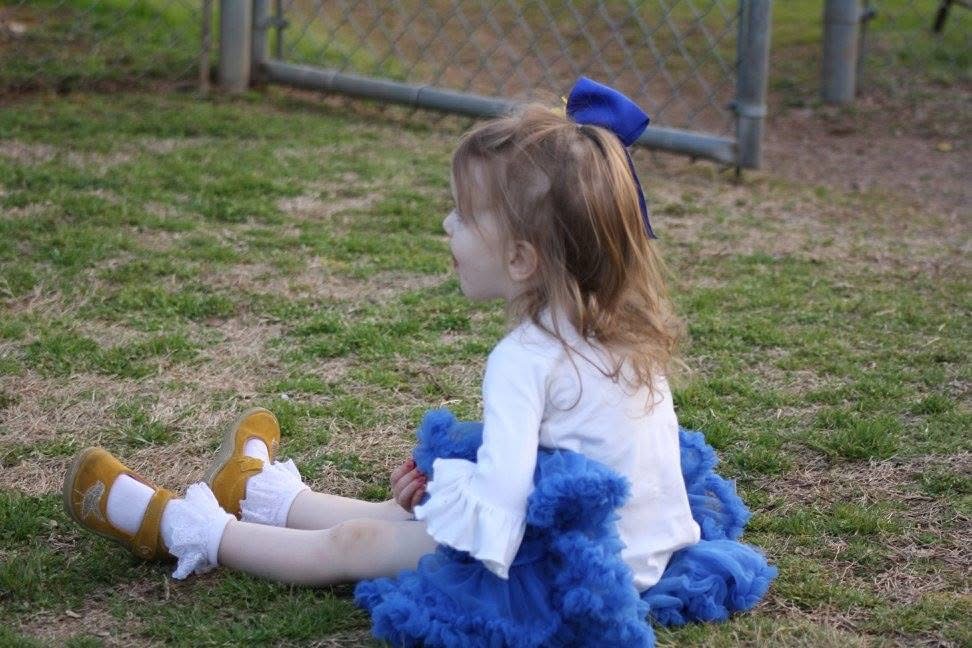 Young Heritage Christian supporter dressed in HC blue and gold at the baseball field
