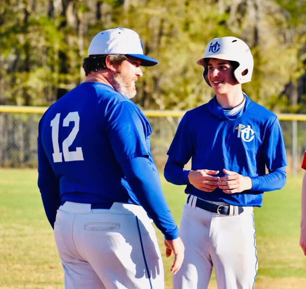 Coach Clay encouraging an HC Baseball player during a game