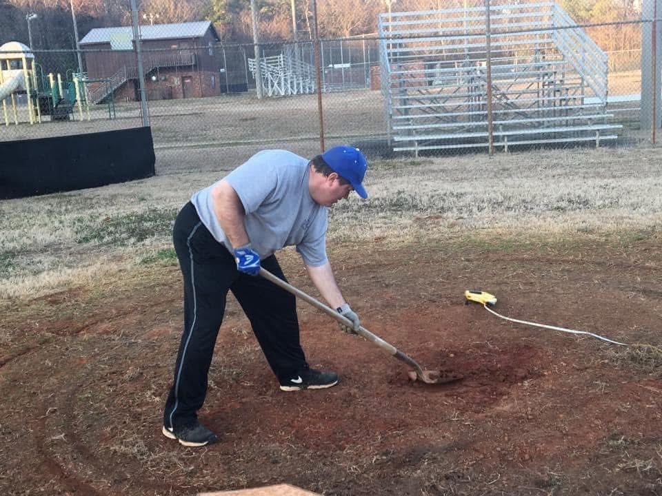Coach Clay working on the HC Baseball field