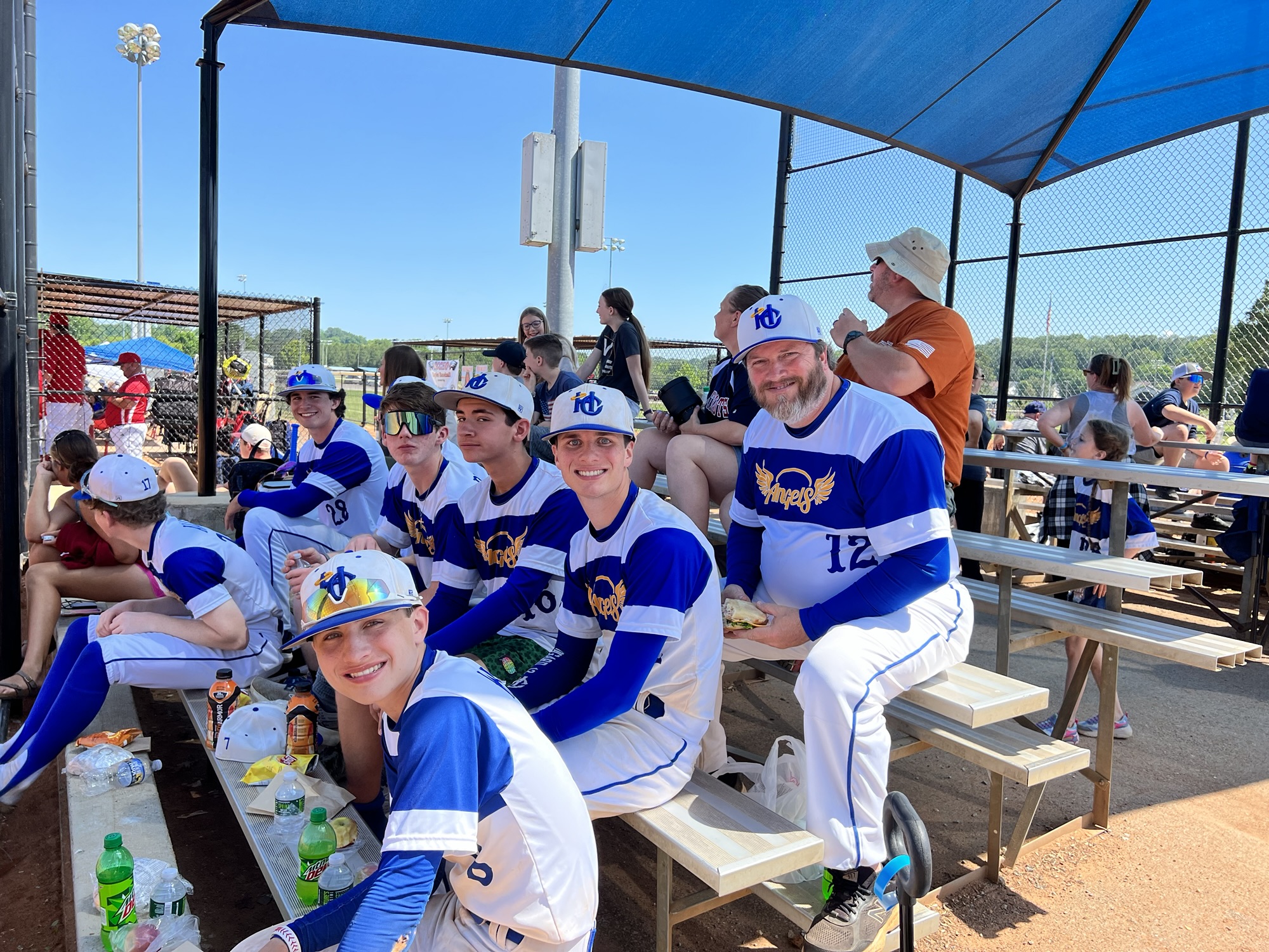 Heritage Christian Angels and Coach Clay together at the ballfield